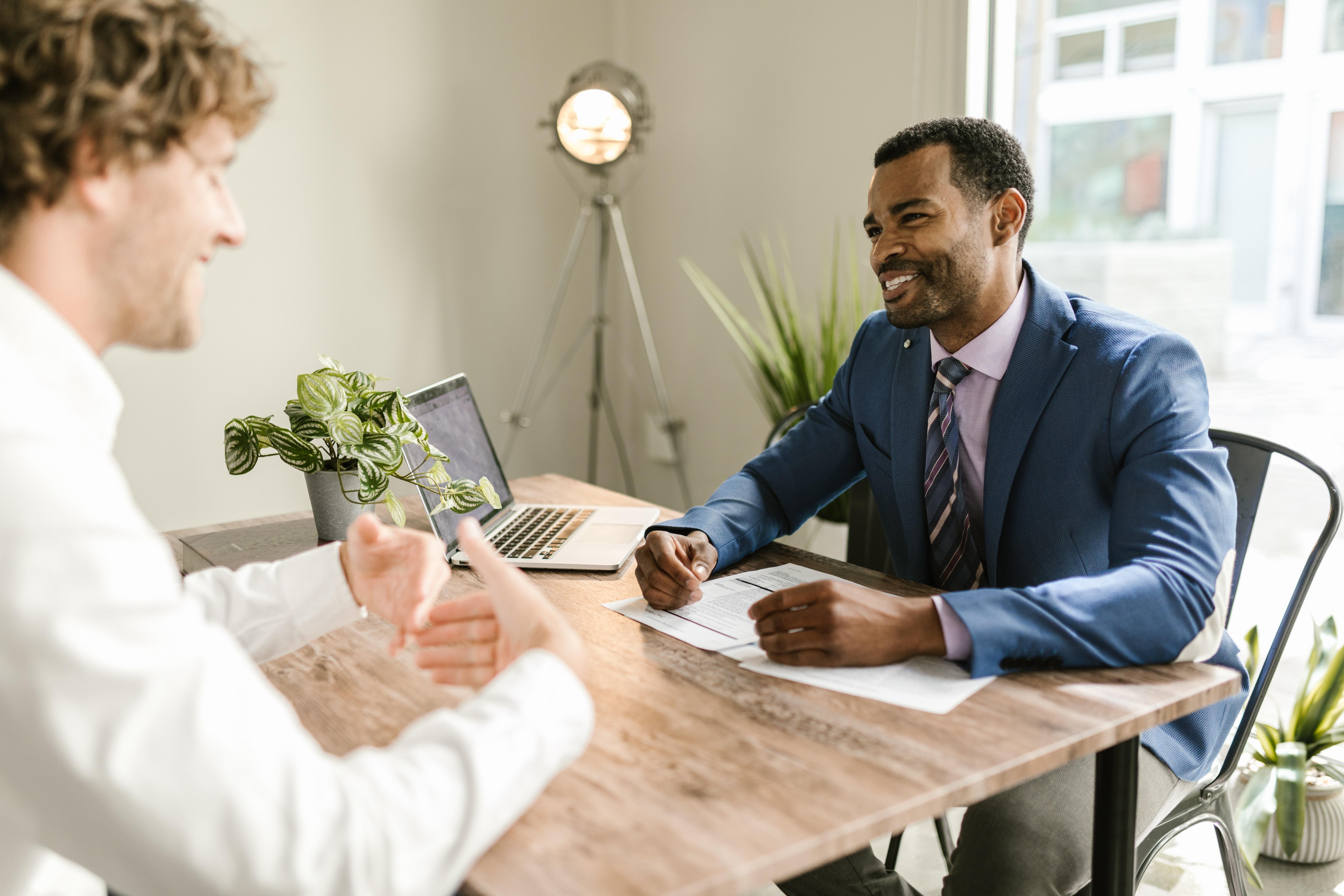 sem/men-talking-across-desk